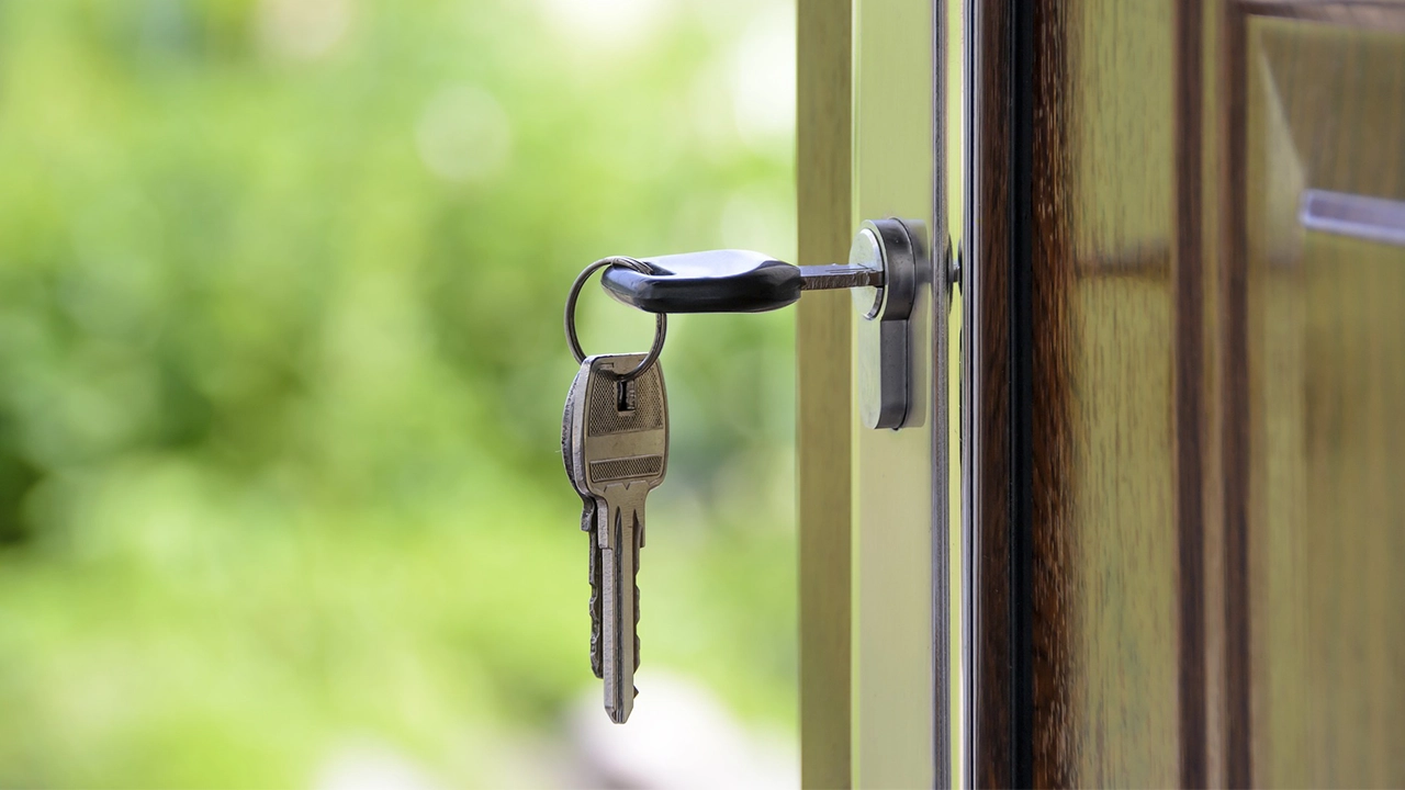 An image of a key in the lock of a door.