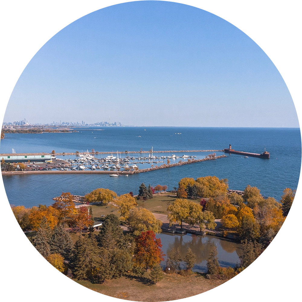 An image cropped in a circular format of the Port Credit harbourfront and breakwater taken by port credit real estate agent Marco Pedri, Broker with Shoreline Realty Corp., Brokerage.