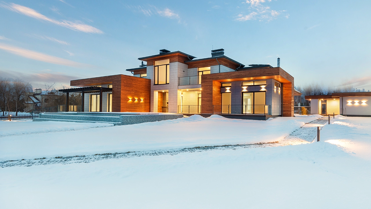 An exterior image of a beautiful mansion home during the winter months of December, January or February with snow on the ground providing a perfect example of great winter curb appeal.