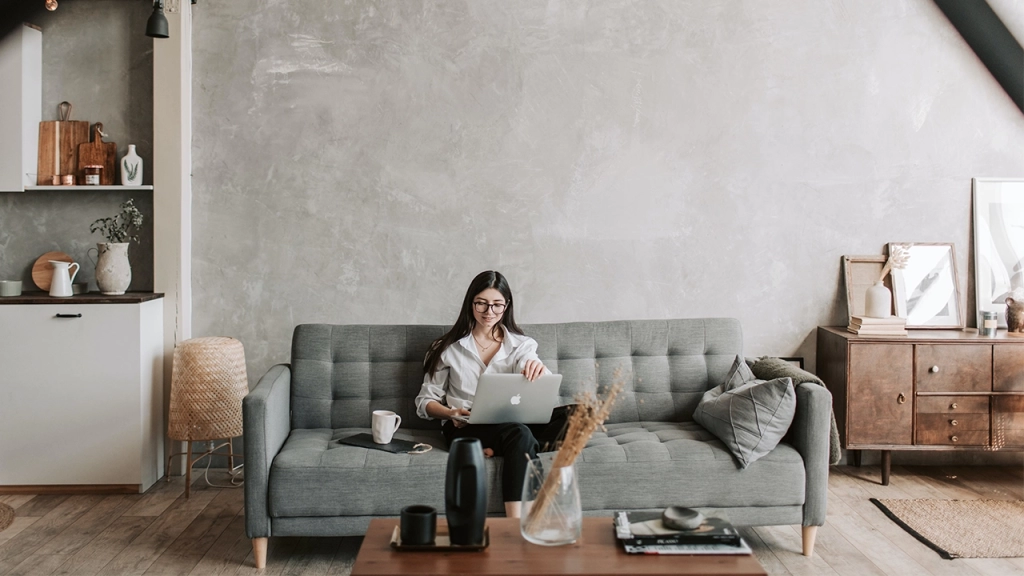 A young Toronto resident sits in their Toronto loft which could either be a hard loft or soft loft - but what is the difference of a hard loft vs soft loft.