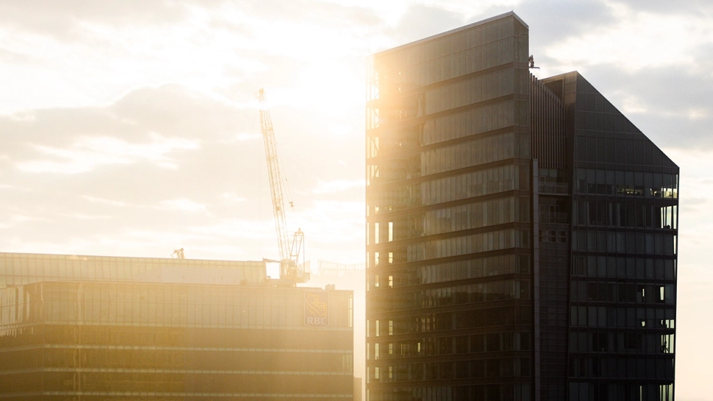 An image of a Toronto condo under construction with the sun setting.