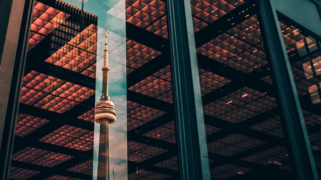 An image of a reflection of the CN Tower in the Financial District of Downtown Toronto.