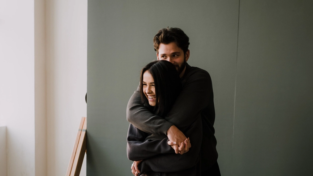 A young couple excited that they won a rental bidding war having read how to win a rental bidding war by Toronto rental agent Marco Pedri