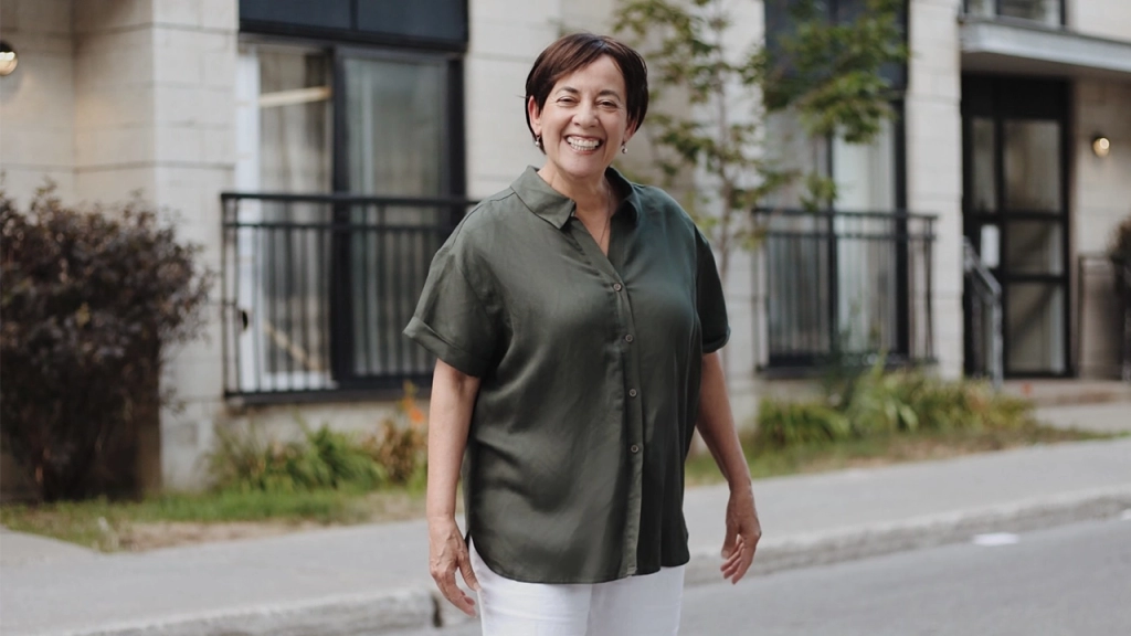 A mature senior lady smiling while moving for her downsizing after retirement journey.