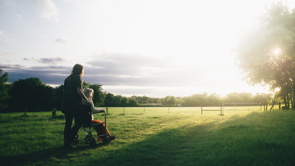 An image of two older mature people overlooking open acerage.