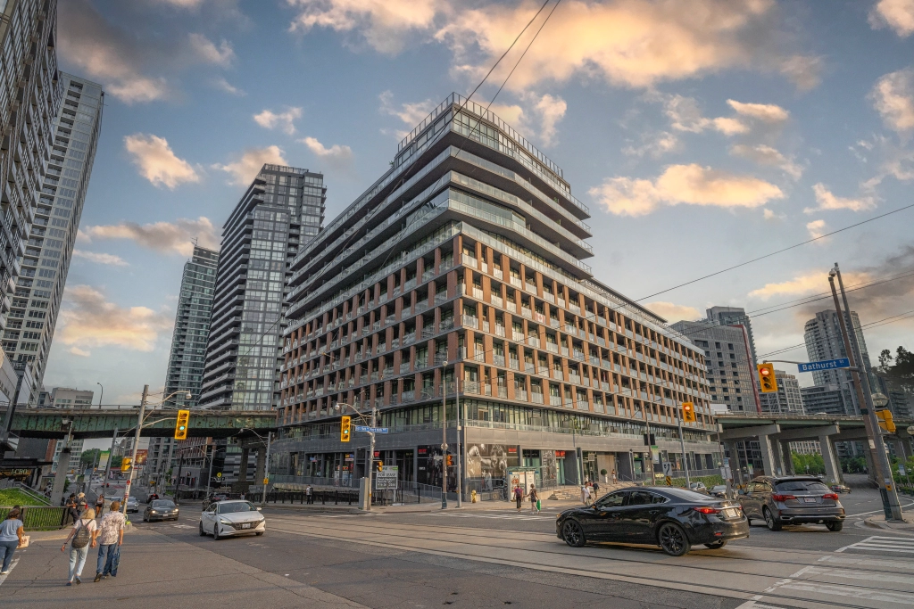 Exterior image of 169 Fort York Boulevard located in Toronto, Ontario, Canada taken from the north east corner of the Bathurst and Fort York Blvd intersection looking South West at the building during a sunset.