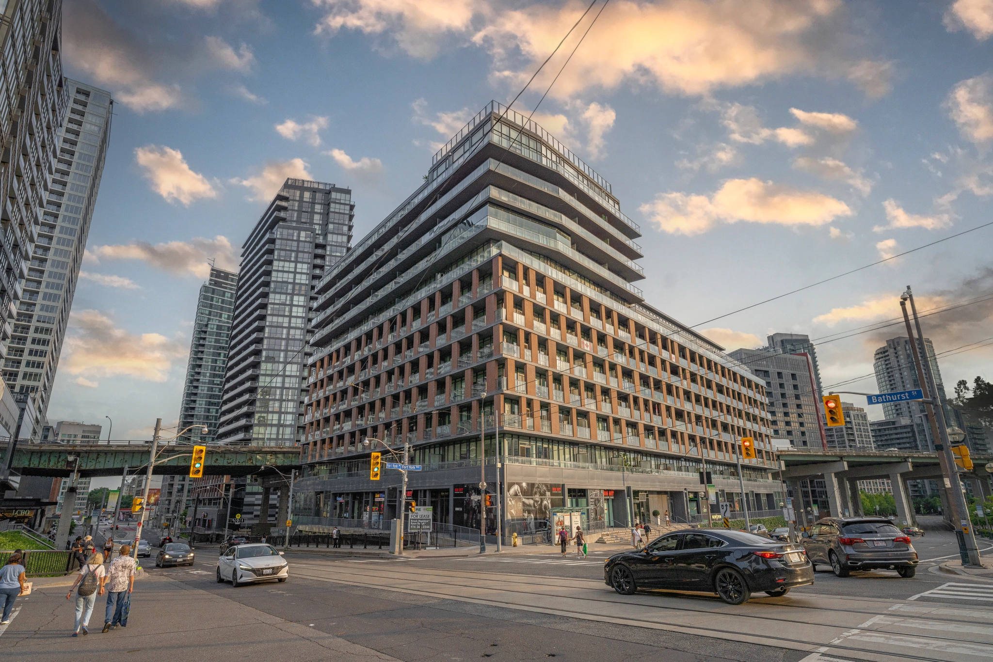 Exterior image of 169 Fort York Boulevard located in Toronto, Ontario, Canada taken from the north east corner of the Bathurst and Fort York Blvd intersection looking South West at the building during a sunset.