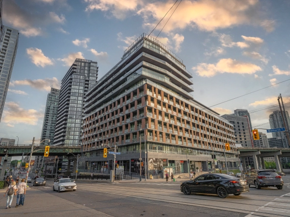 Exterior image of 169 Fort York Boulevard located in Toronto, Ontario, Canada taken from the north east corner of the Bathurst and Fort York Blvd intersection looking South West at the building during a sunset.