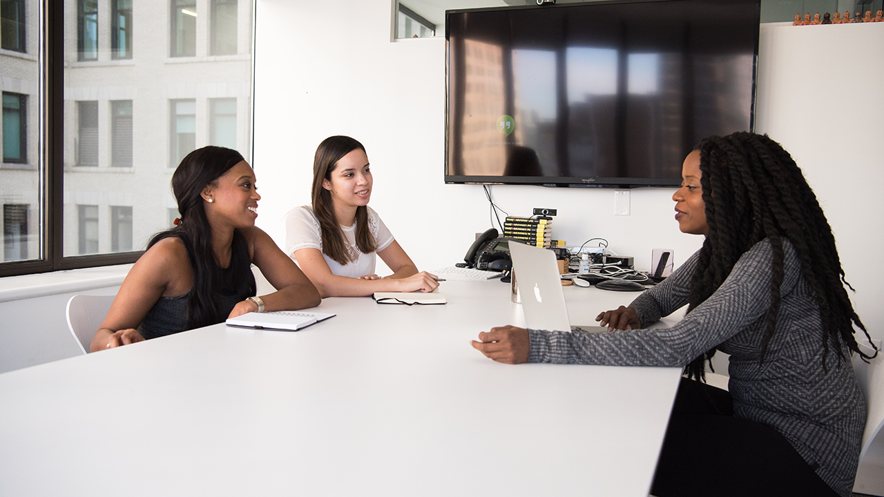 An image of a real estate agent and their client responding to an offer.