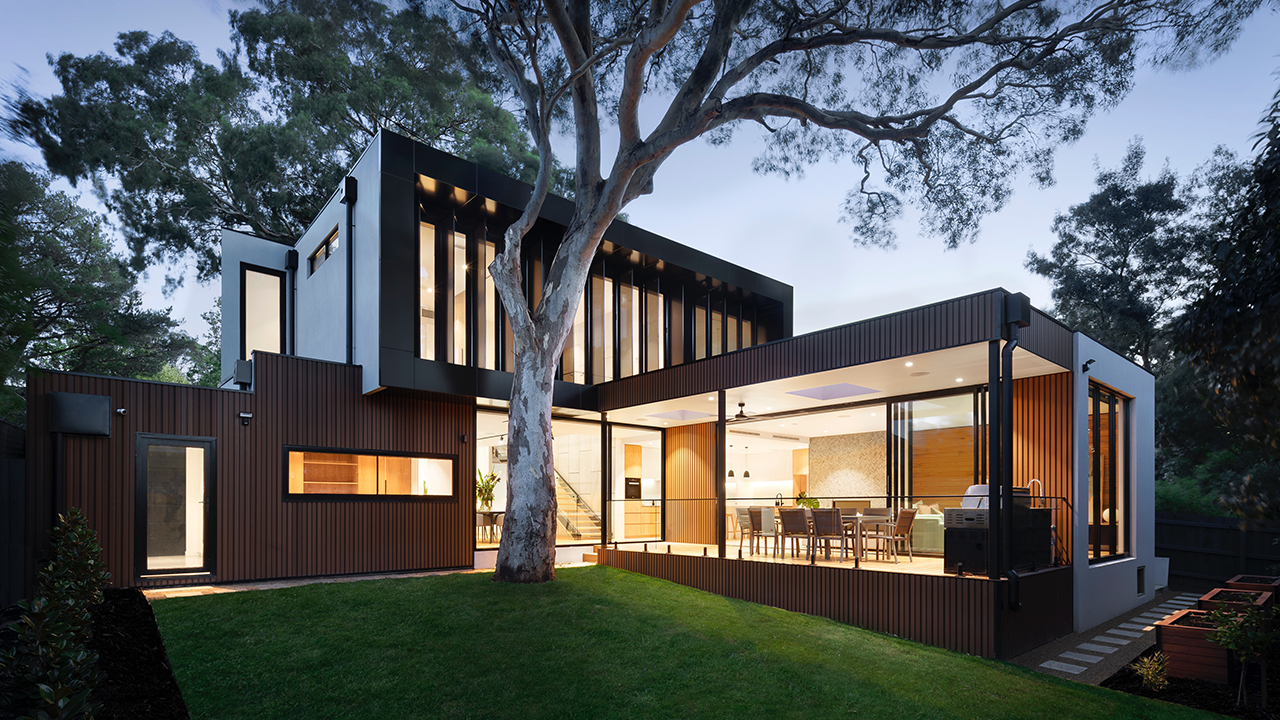 An image of the exterior of a luxury home during the evening twilight hour.