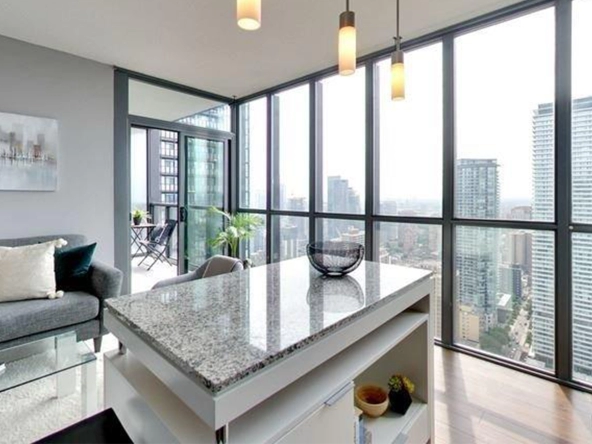 Kitchen island and view from floor-to-ceiling windows of 110 Charles Street East #4204