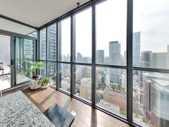 View through floor-to-ceiling windows of 110 Charles Street East #4204