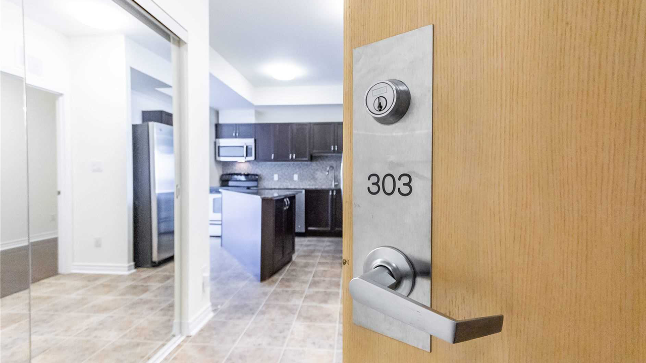 The door handle depicting unit 303 as you enter into the unit of 3865 Lake Shore Blvd West #303 - For Lease in Etobicoke.