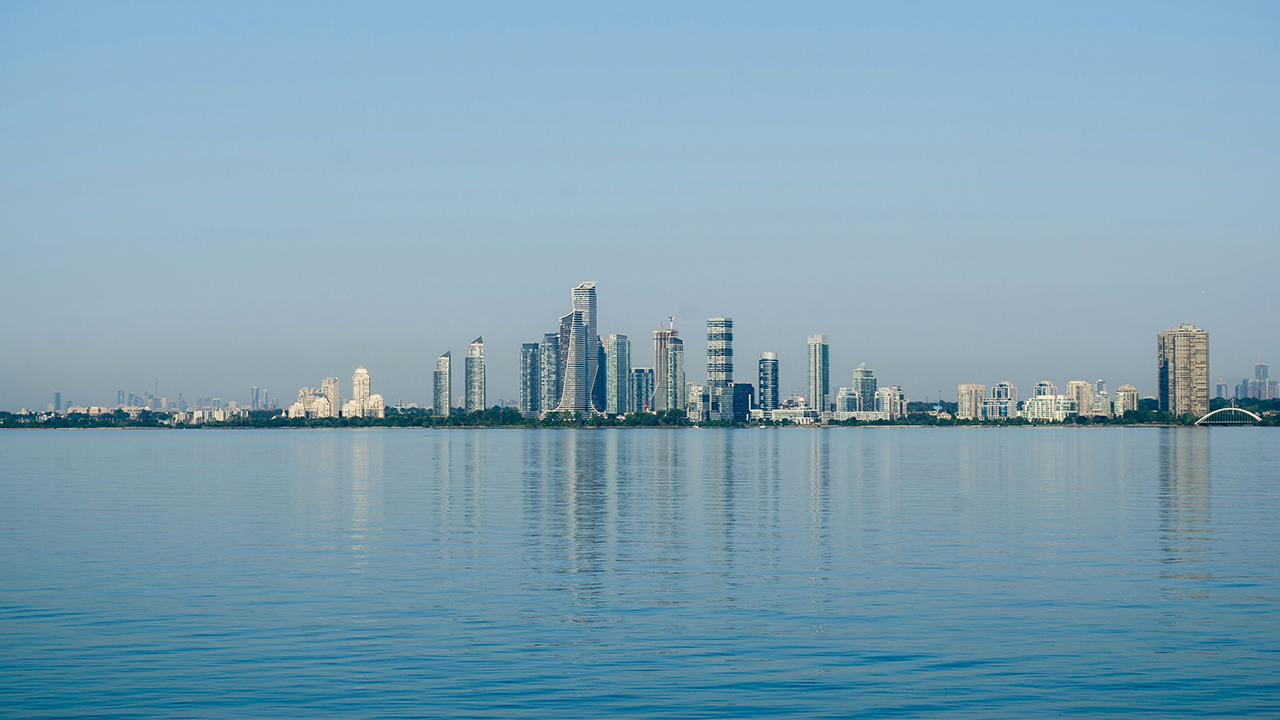 An image of the Etobicoke skyline with Lake Ontario in the forefront.