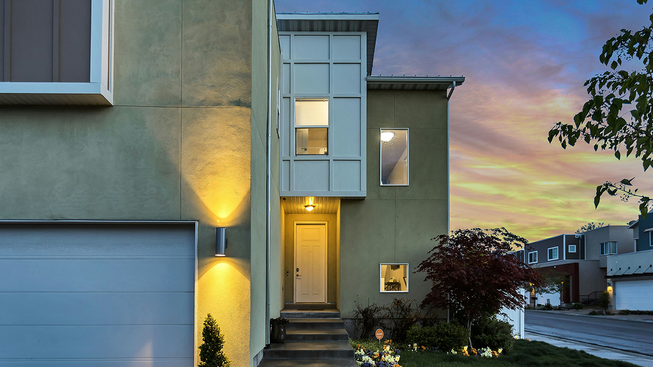 An exterior image of a townhouse home during a beautiful sunset.