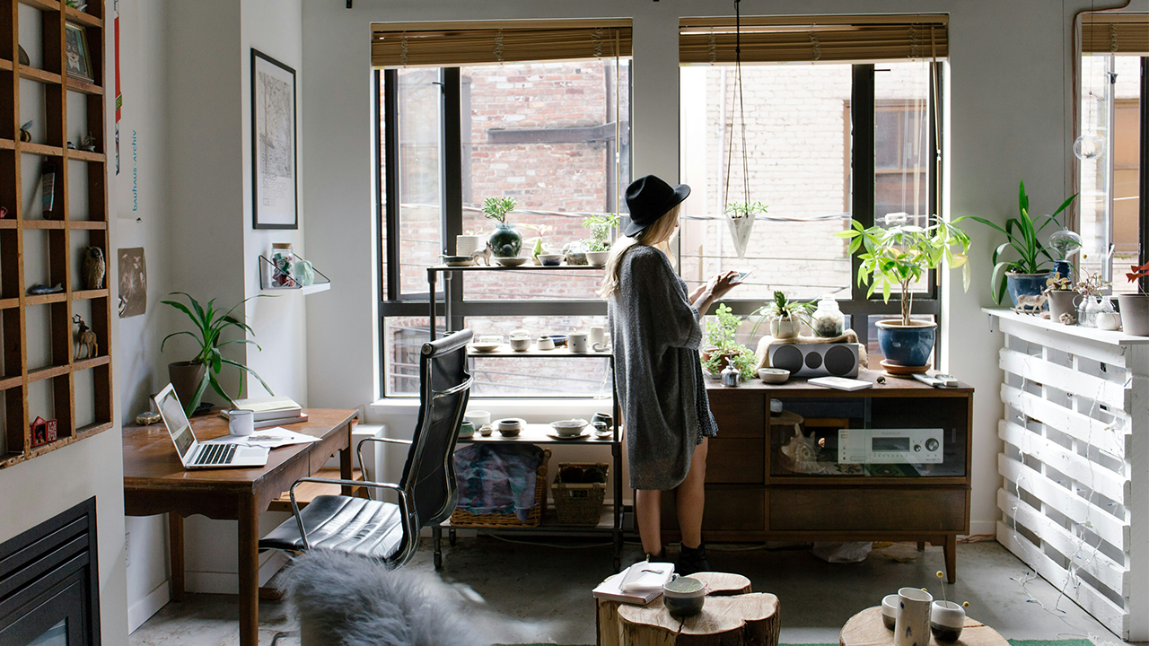 An image of a person standing in their studio apartment. What is a studio apartment?