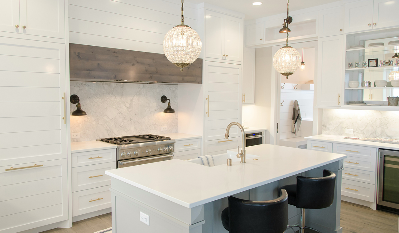 An interior image of a beautiful, modern white kitchen.