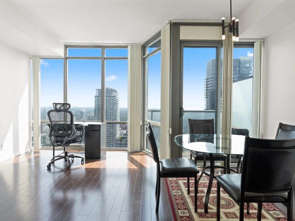 Image of the living room and dining room with floor to ceiling windows at 832 Bay Street unit 4807 located in Toronto, Ontario, Canada.