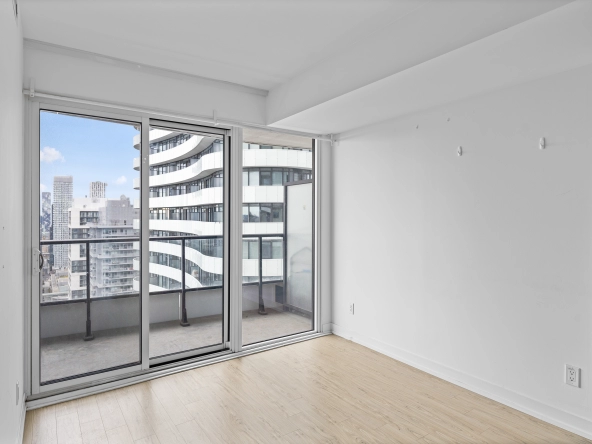 Living room with walk-out to balcony of 85 Wood Street unit 3717 - a 2 bedroom, 1 bathroom unit for lease in Toronto listed by Toronto Rental Agent Marco Pedri.