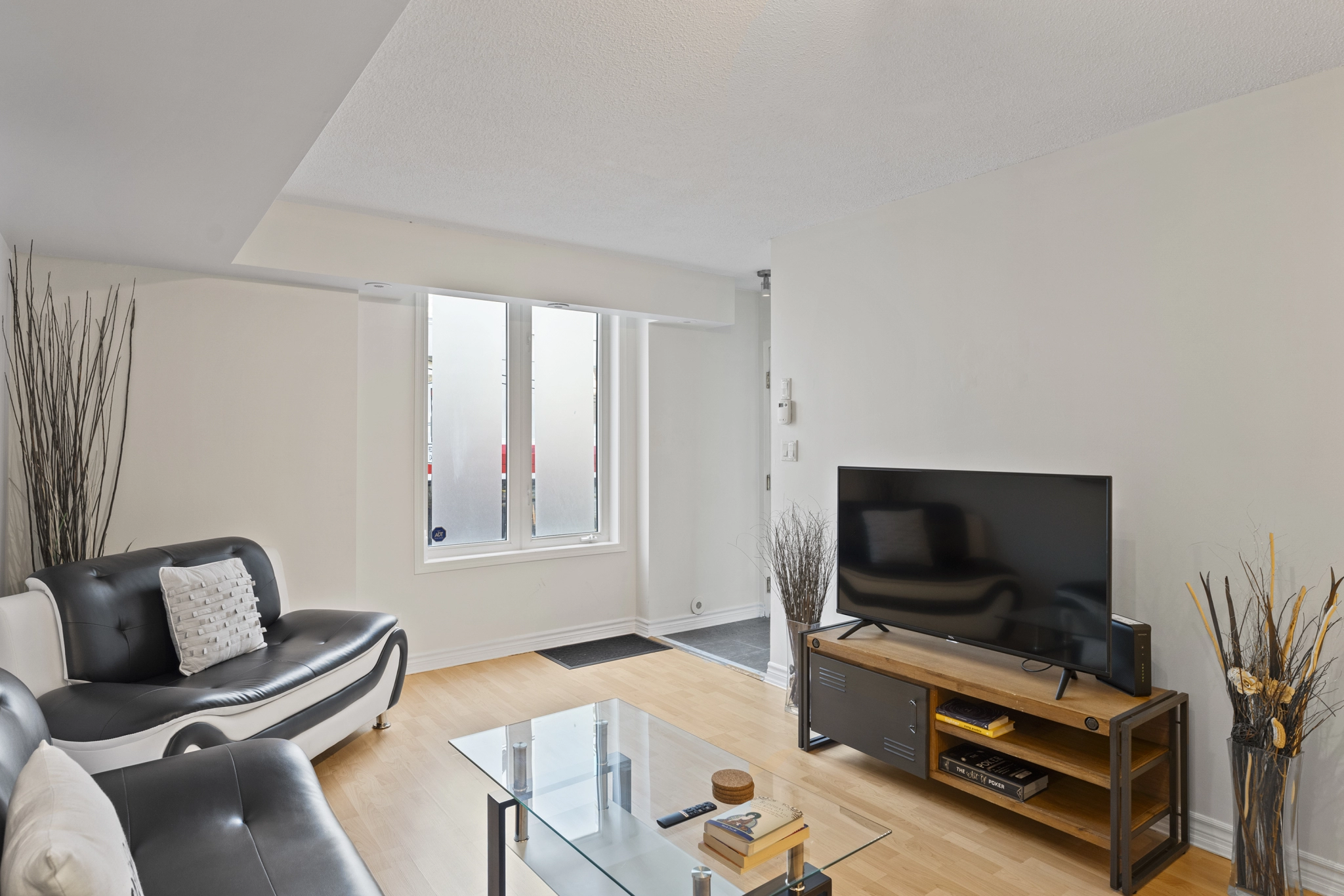 Living room and front door entrance of 96 Strachan Avenue located in the neighbourhood of Liberty Village in Toronto, Ontario currently listed for lease by Liberty Village real estate agent Marco Pedri.