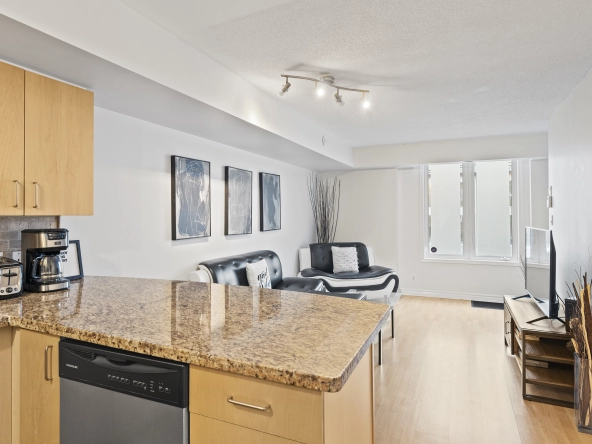 Kitchen and living room of 96 Strachan Avenue located in the neighbourhood of Liberty Village in Toronto, Ontario currently listed for lease by Liberty Village real estate agent Marco Pedri.