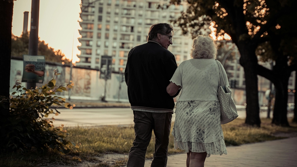 An elderly couple walking through Toronto.