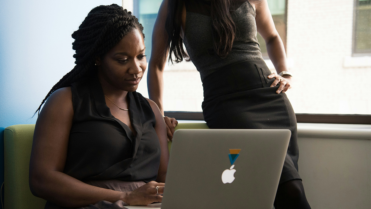 An image of a property manager looking at their laptop computer.