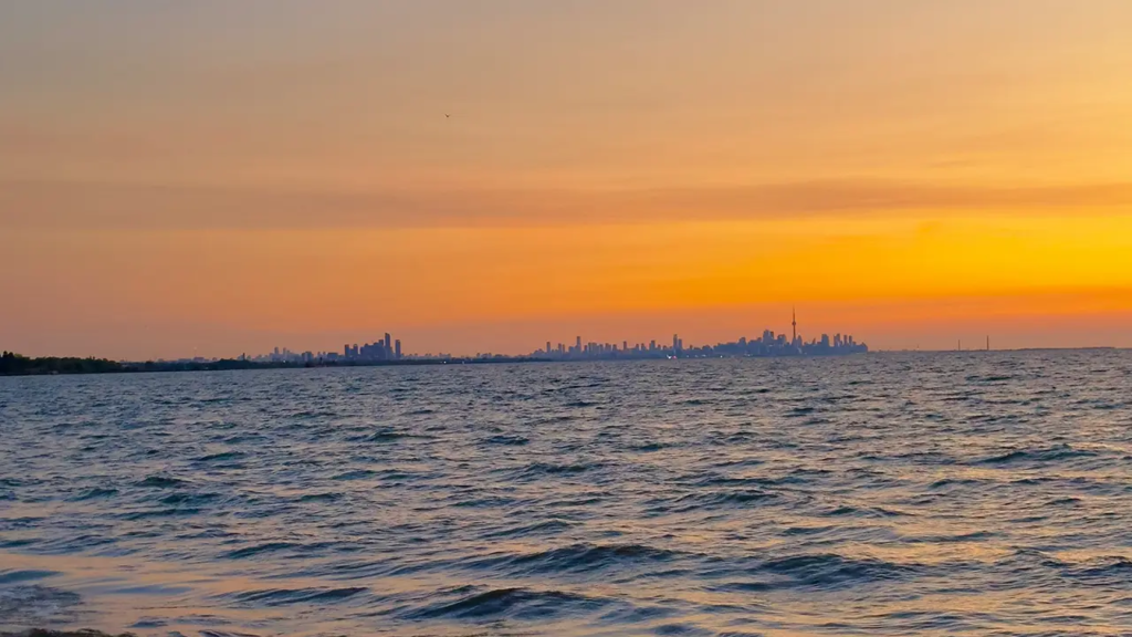 An image of Lake Ontario from as seen from Port Credit during a beautiful sunset with Toronto in the background.