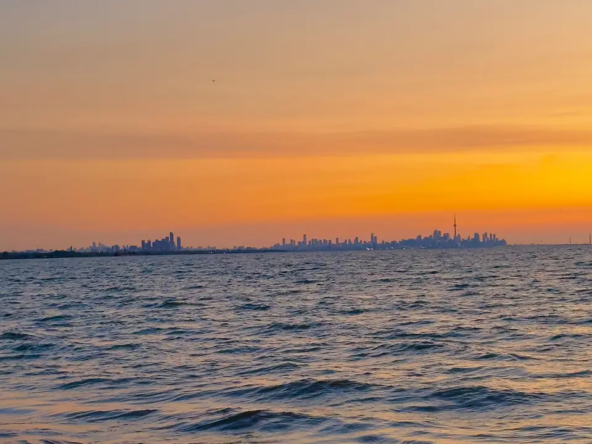 An image of Lake Ontario from as seen from Port Credit during a beautiful sunset with Toronto in the background.