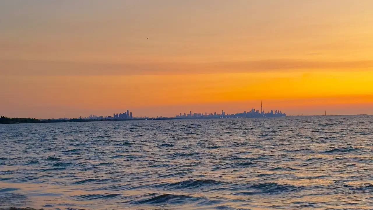 An image of Lake Ontario from as seen from Port Credit during a beautiful sunset with Toronto in the background.