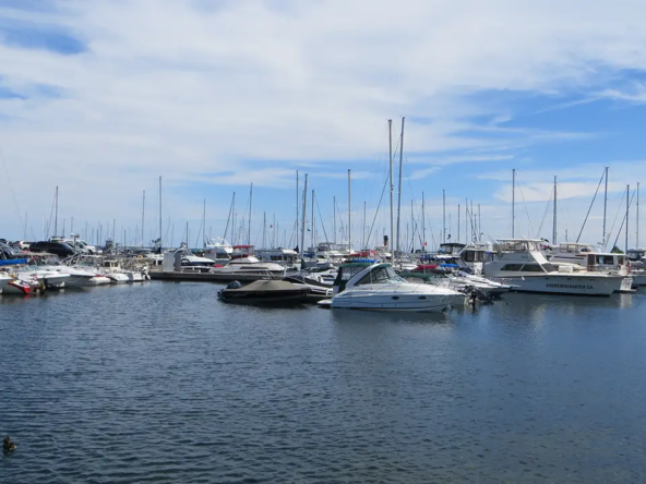 An image of the harbour of Port Credit with a boat which illustrates the real cost of living in Port Credit.